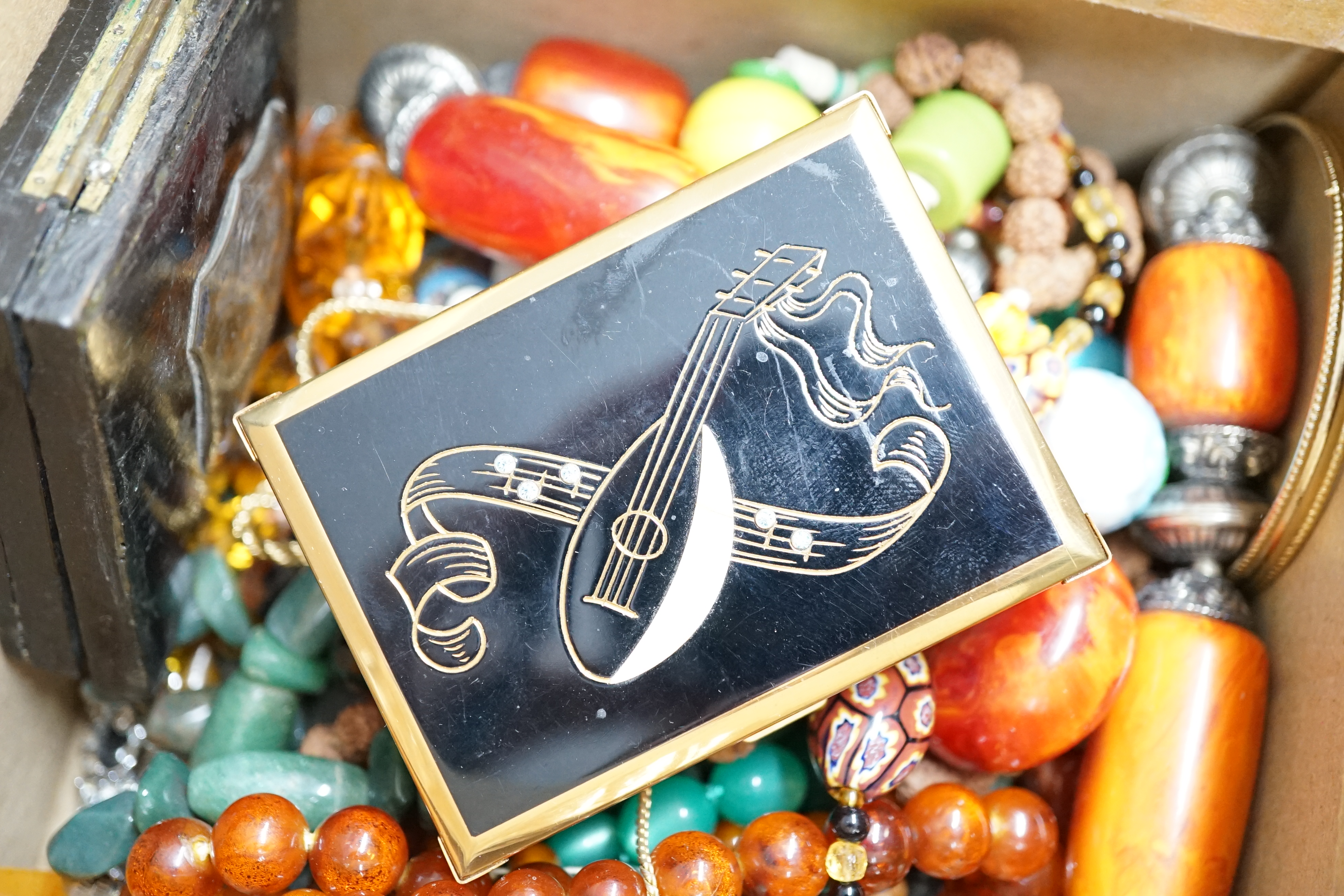 A group of assorted costume jewellery including a musical compact